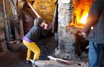 Harvey working the bellows at Strachur Forge